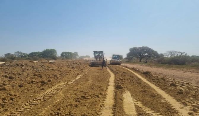 Motor grader shaping a murram road formation near Rumbek