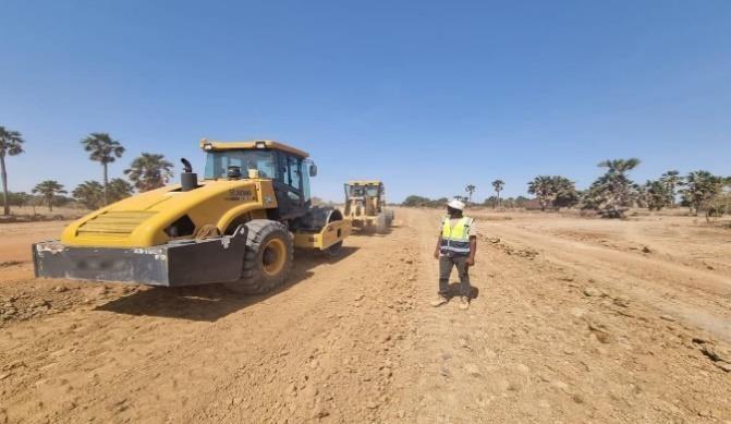 Site technicians carrying out field density testing on a compacted layer