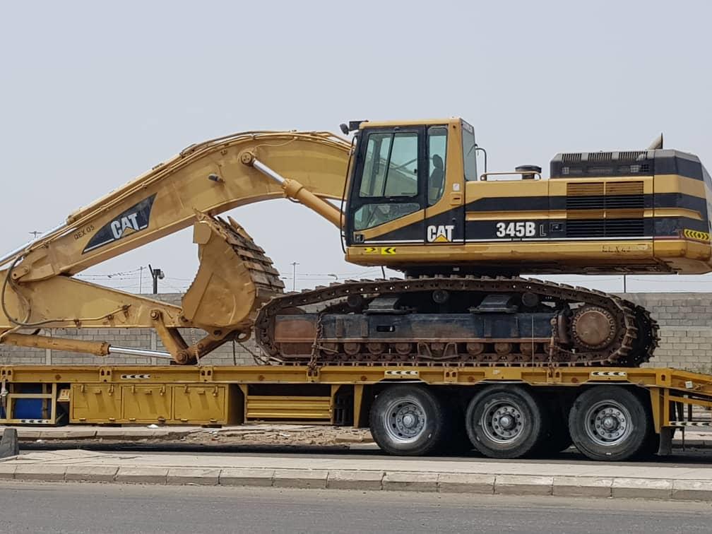 Excavator loaded on a low-bed trailer for transport