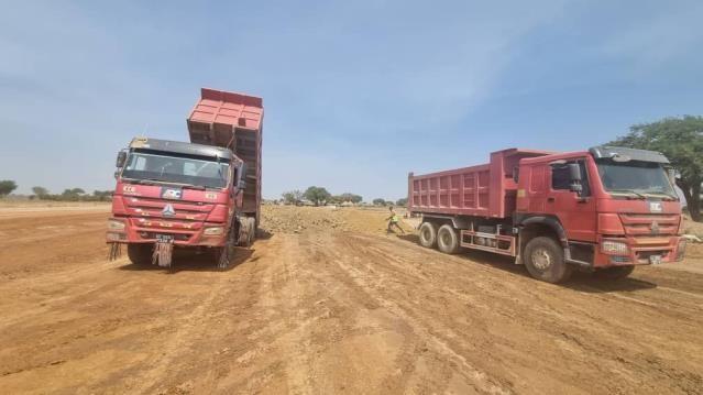 Surveyor setting out levels on a road alignment